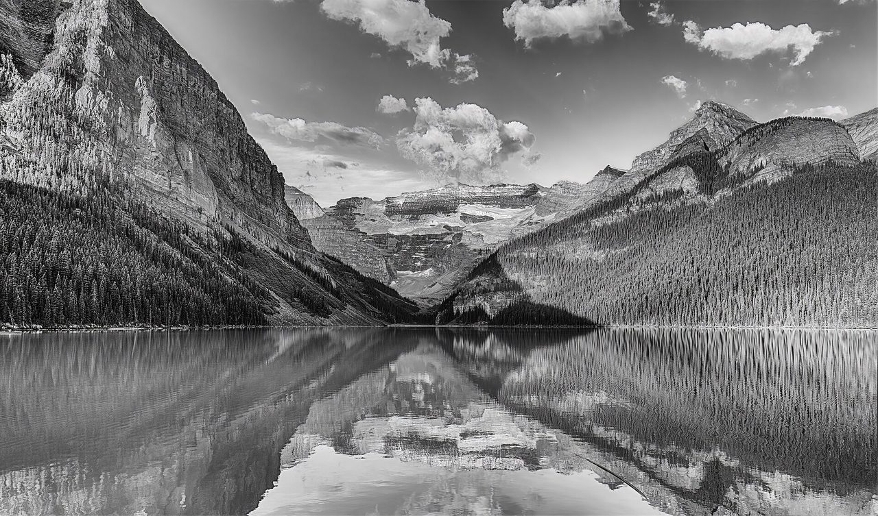 Alpine glow reflecting on Lake Louise in Banff National Park with Mount Victoria rising behind the turquoise water