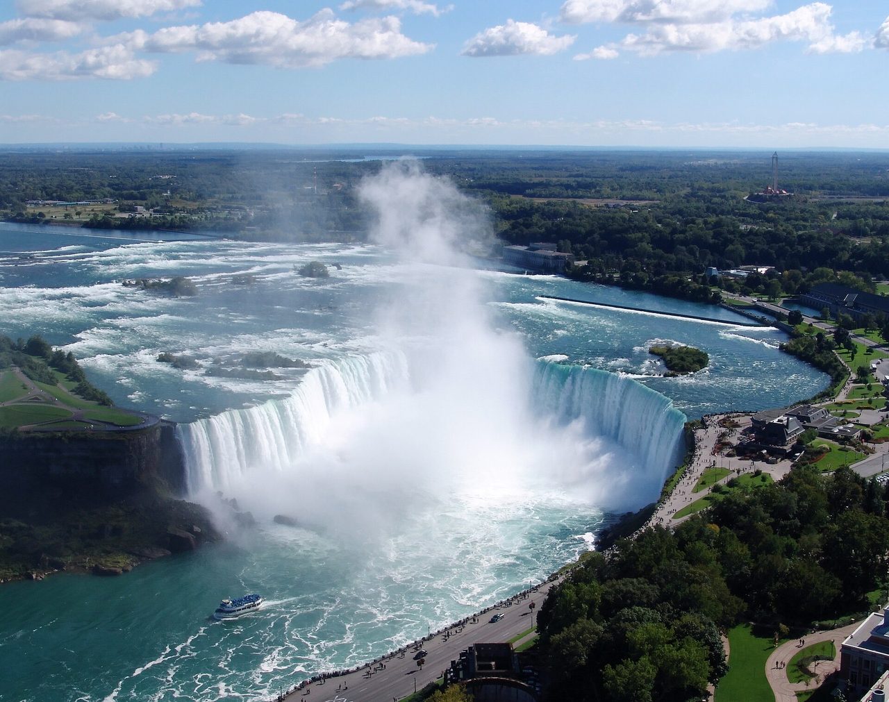 The Horseshoe Falls at Niagara Falls thundering over the curved cliff edge with mist rising