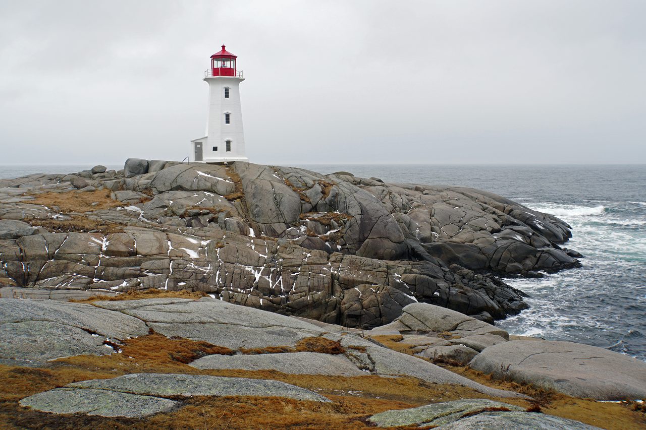 Peggy's Cove lighthouse on wave-washed granite rocks in Nova Scotia