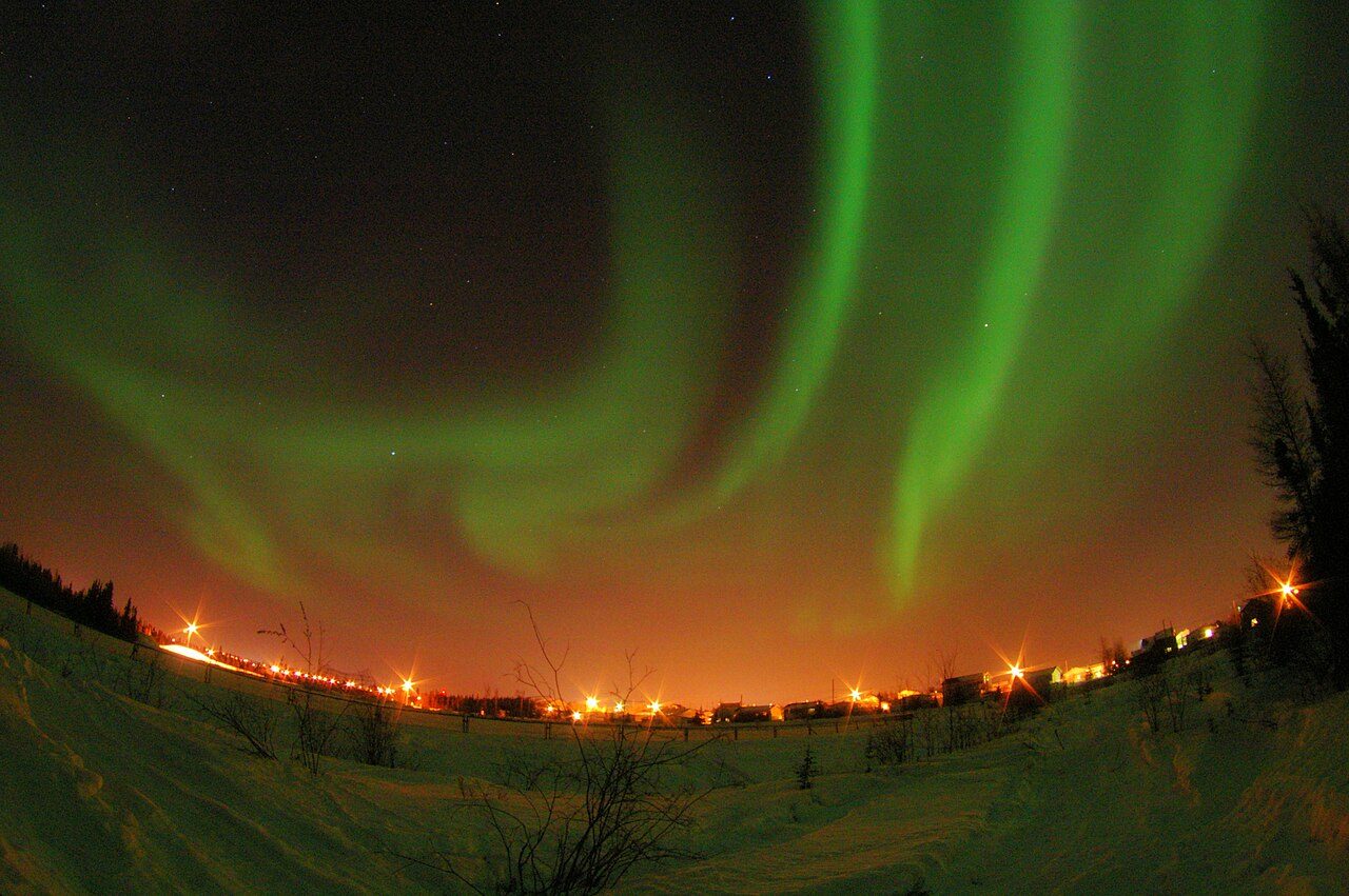Green northern lights rippling across the night sky over Yellowknife, Northwest Territories