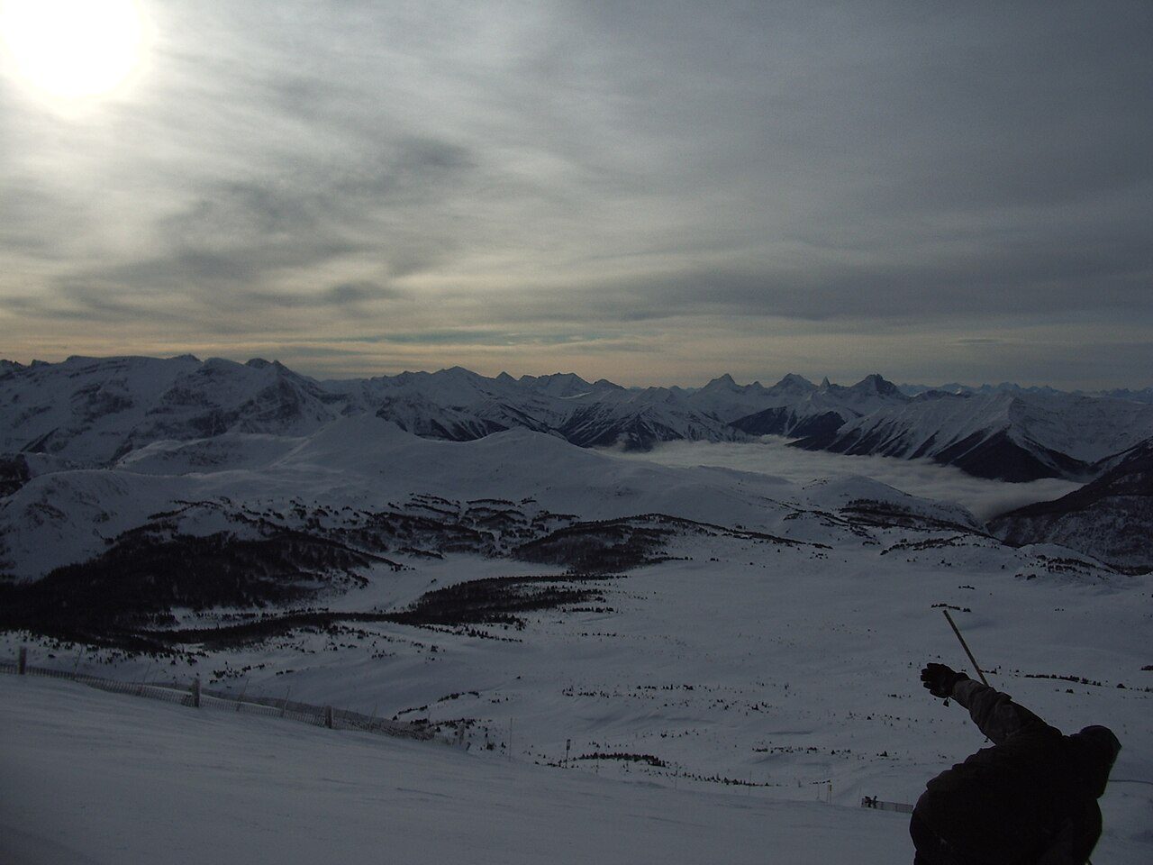 Skiers on groomed slopes at Sunshine Village in Banff National Park on a bright winter day