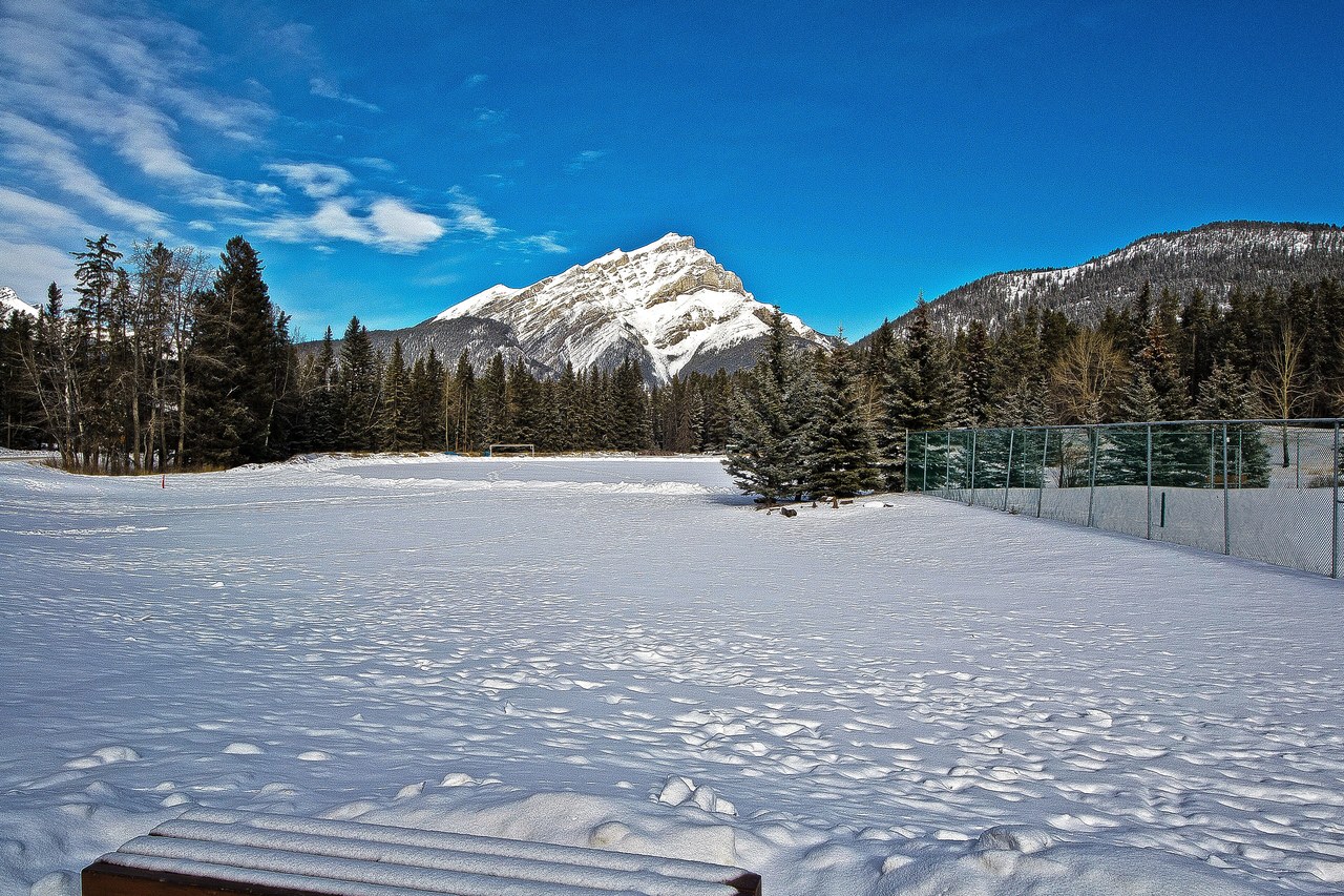 Cascade Mountain rising over Banff in winter with a snowy valley floor