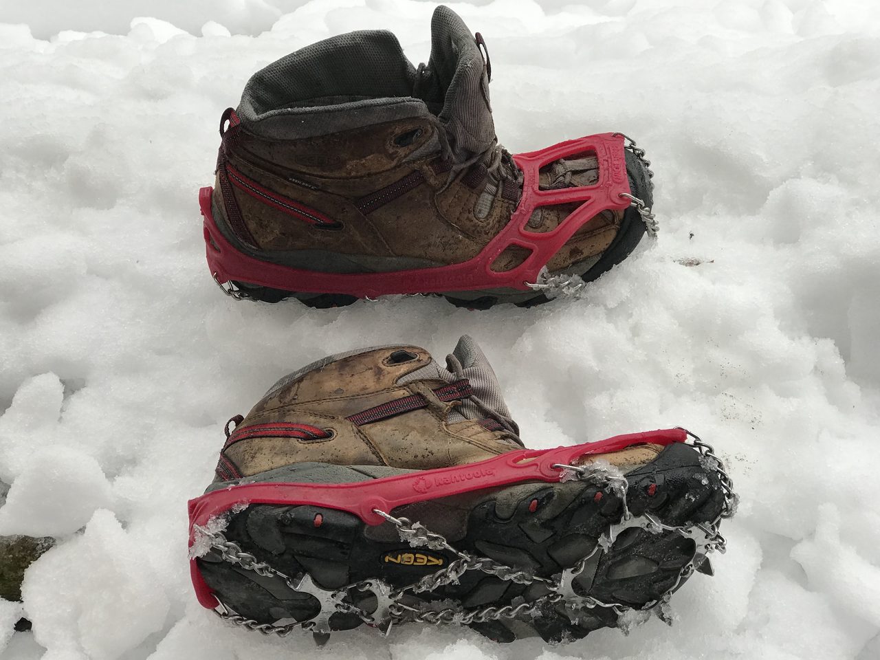 Metal microspikes fitted to hiking boots for traction on ice