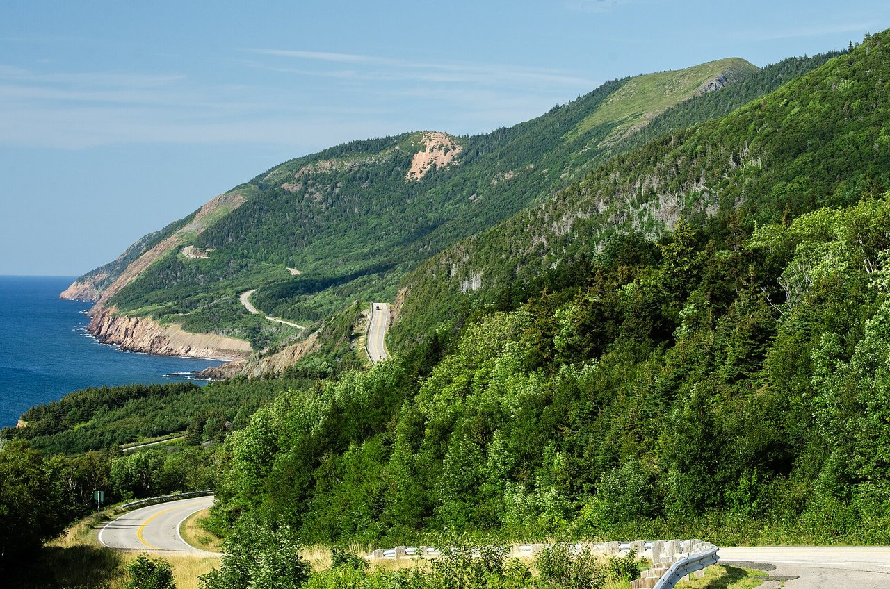 The Cabot Trail winding through the green highlands of Cape Breton Highlands National Park