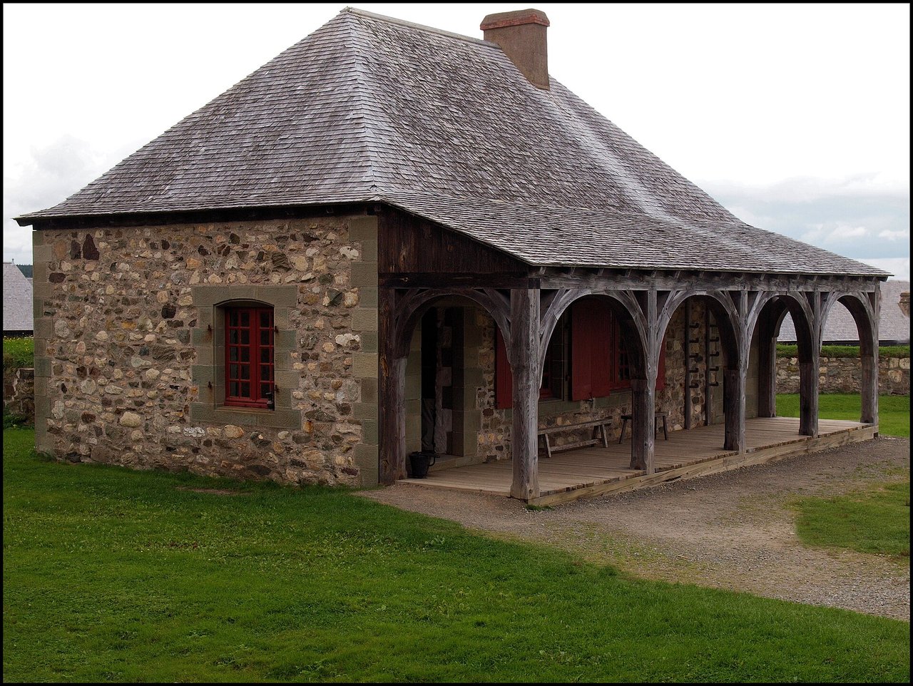 Reconstructed stone buildings and fortifications of the Fortress of Louisbourg under a summer sky