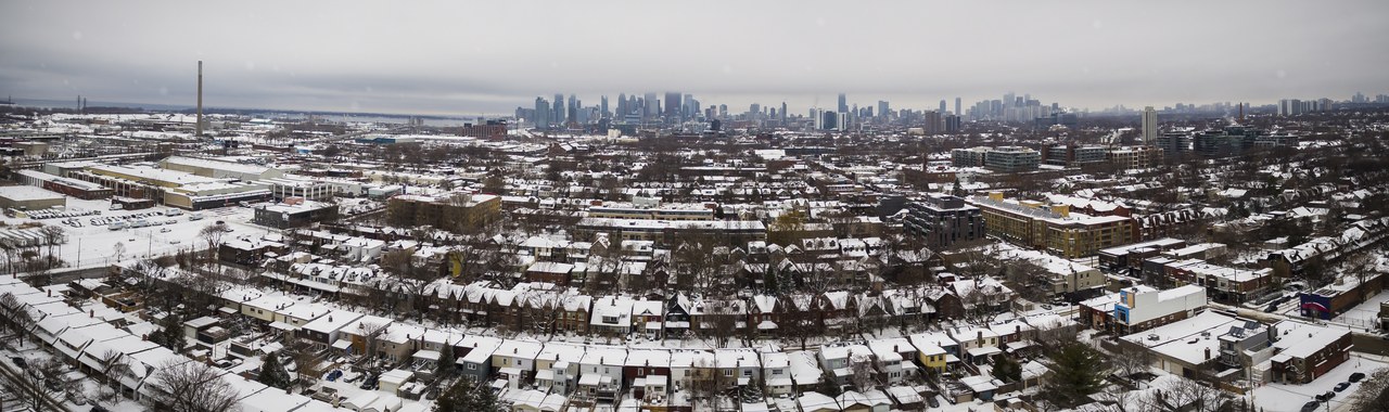 Toronto skyline blanketed in snow on a bright winter day, the cheapest season to visit Canada