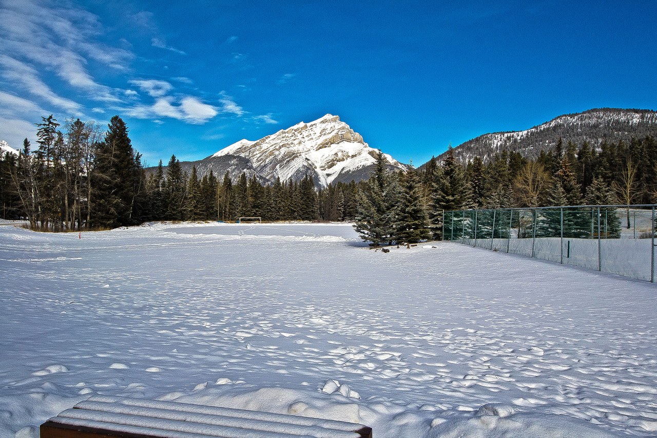 Cascade Mountain towering over Banff in winter, with Canmore offering cheaper stays nearby