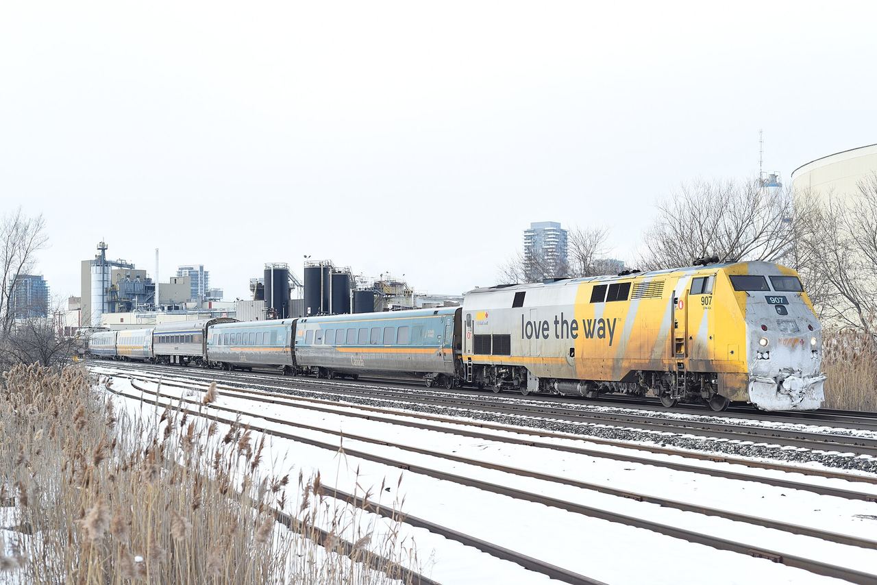 A red and silver VIA Rail passenger train at a platform