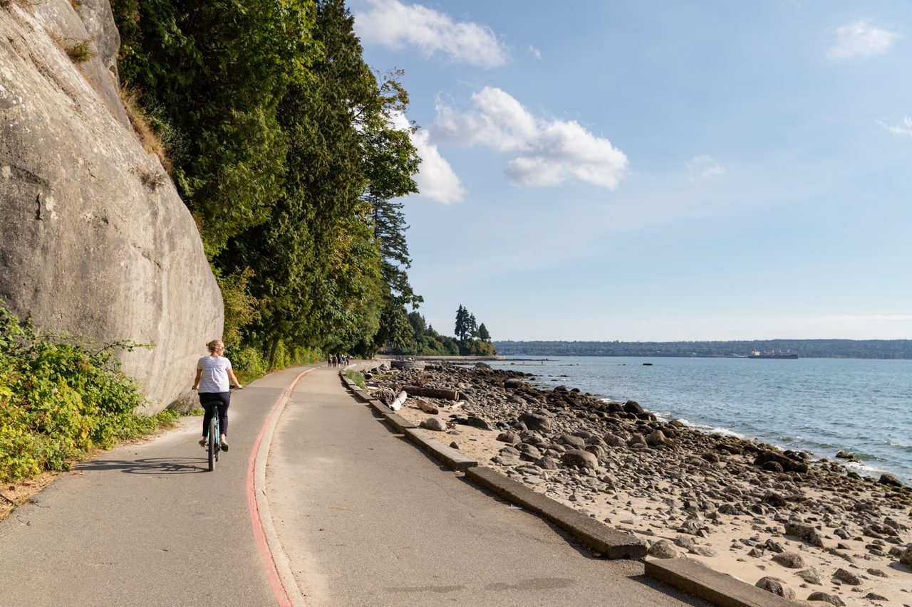Family bike tour riding the Stanley Park seawall in Vancouver