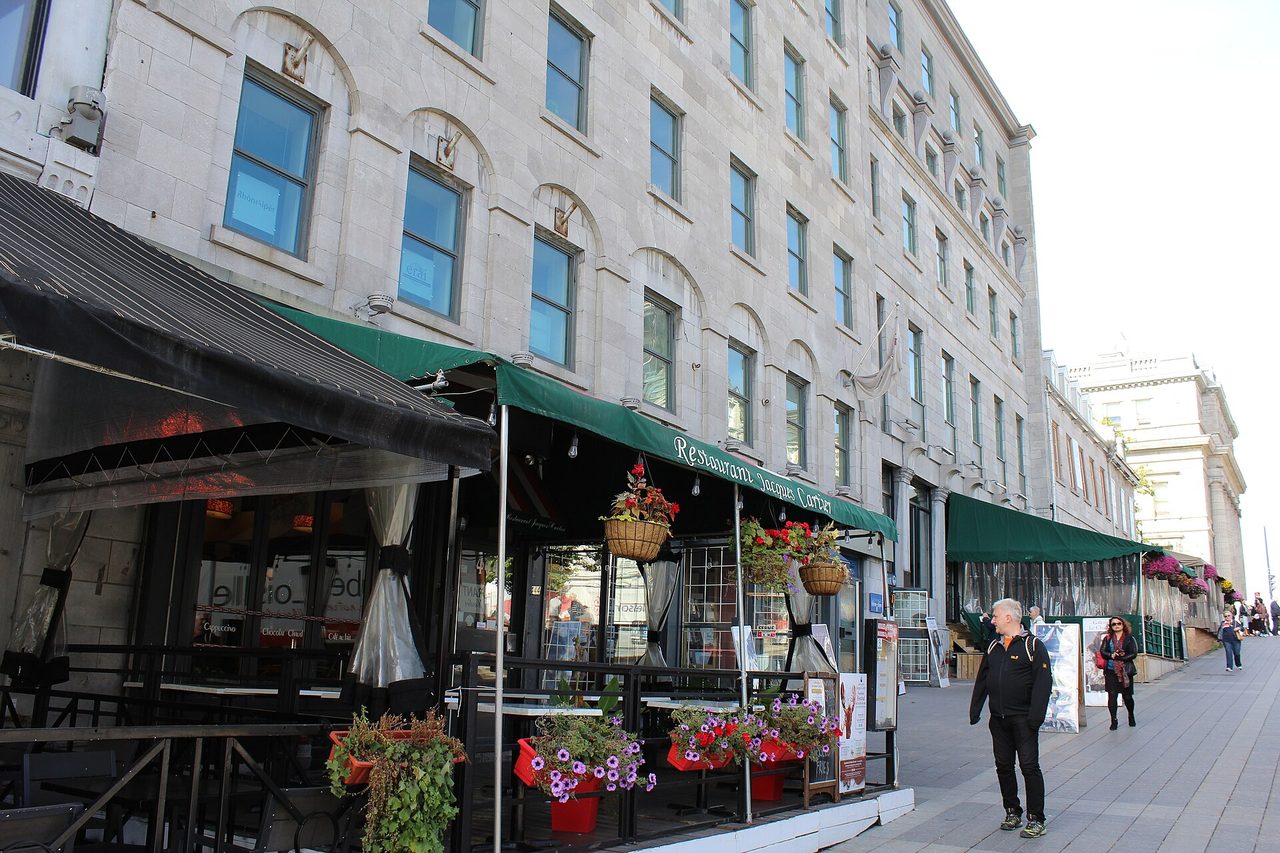 Terrace restaurant with flower baskets on Place Jacques-Cartier in Old Montreal