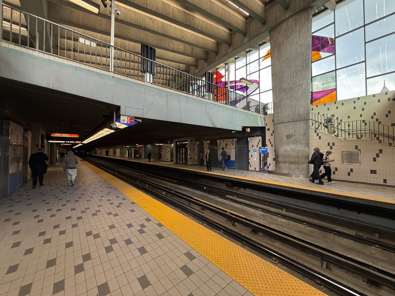 Platform at Champ-de-Mars metro station in Montreal, with its colorful stained-glass windows