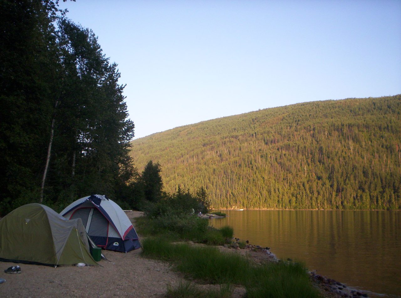 A tent pitched by the shore of Barriere Lake in British Columbia at dusk
