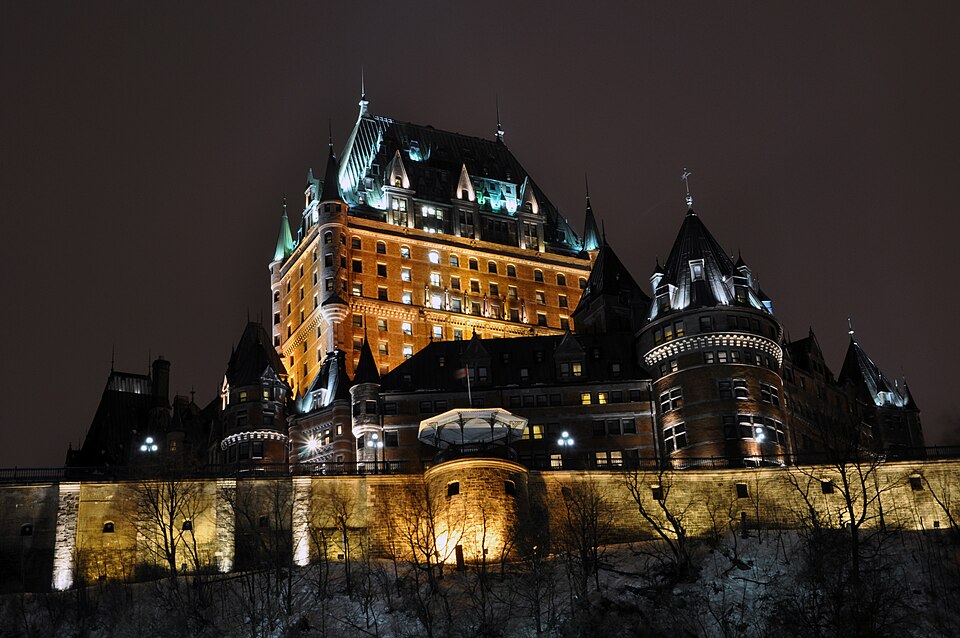 The Château Frontenac glowing above snow-covered Old Québec rooftops on a winter night