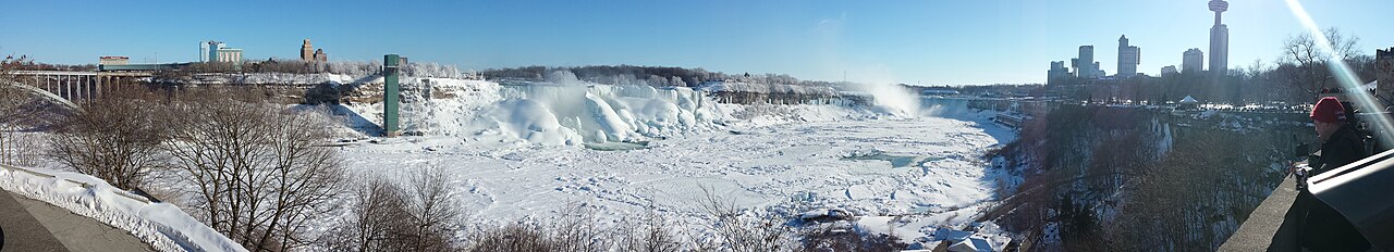 Niagara Falls in winter, mist rising off the partly frozen cascades