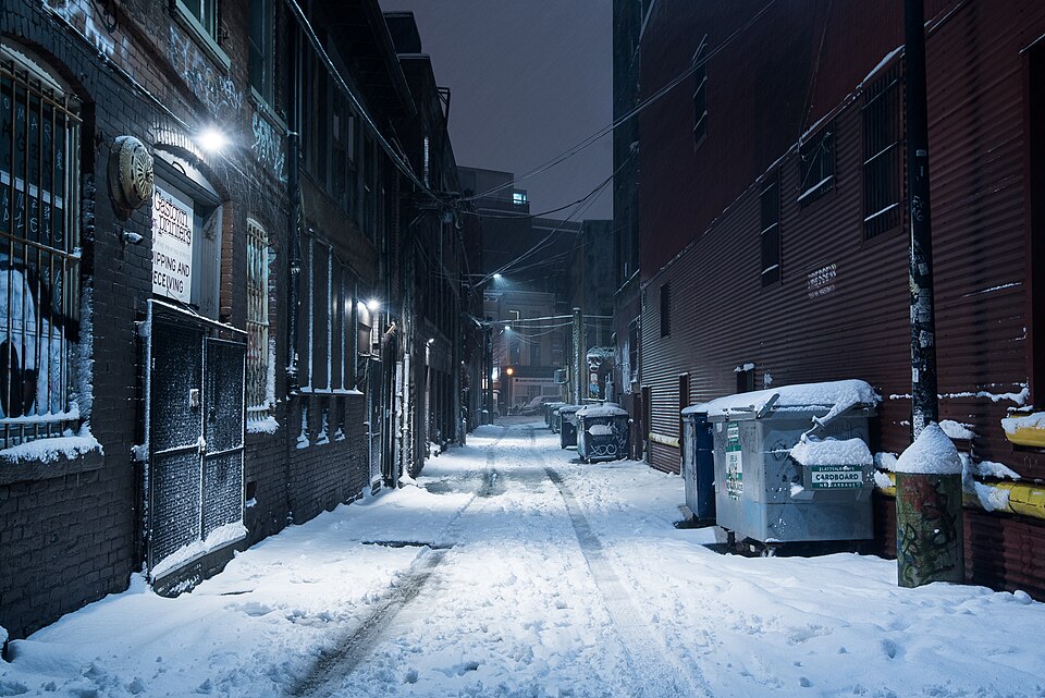 Fresh snow covering a quiet downtown Vancouver alley in winter