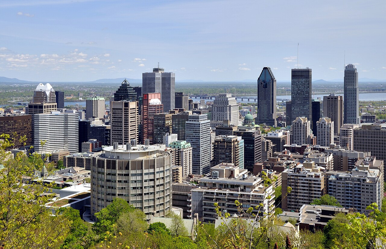 Montreal skyline with downtown towers under a blue summer sky