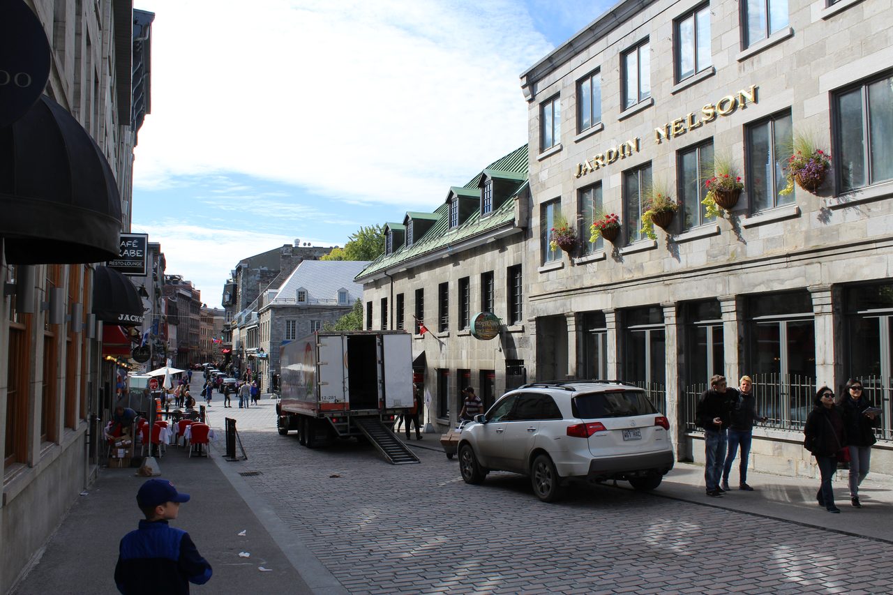 Cobblestone street lined with historic stone buildings in Old Montreal