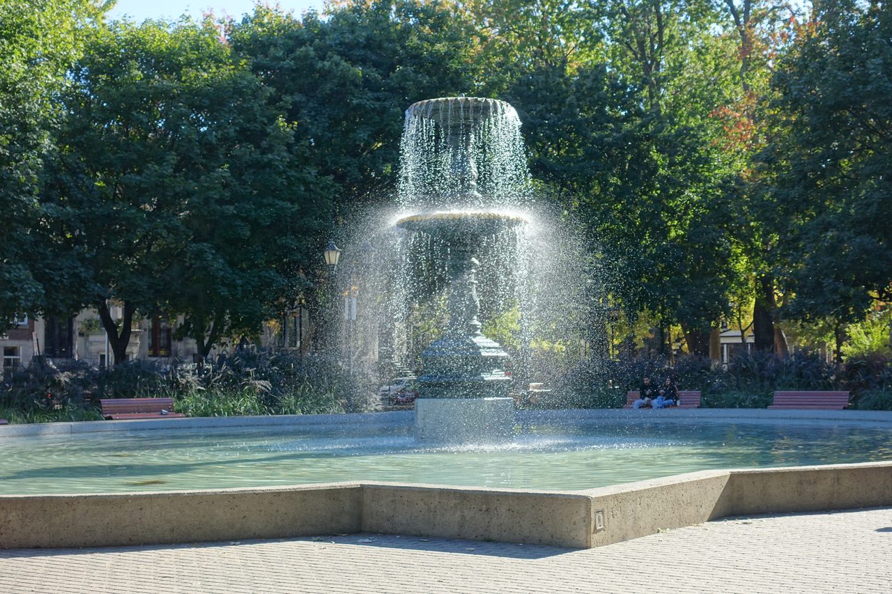Fountain and Victorian row houses at Square Saint-Louis in the Plateau