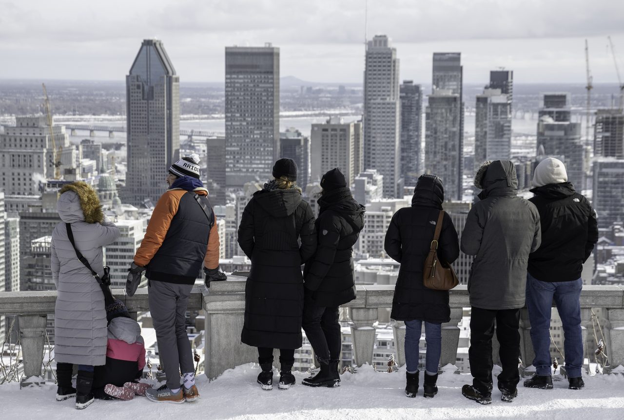 Terrace of the Mount Royal Chalet in winter with the Montreal skyline beyond