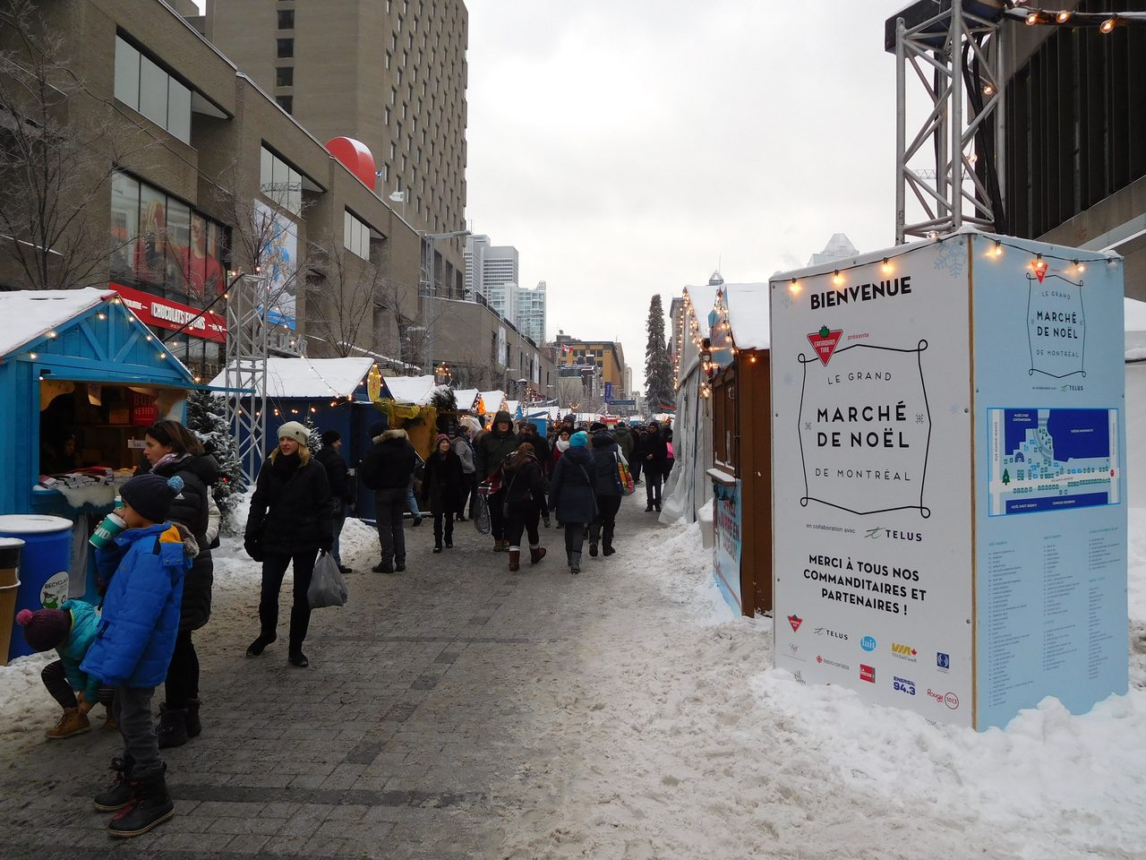 Wooden holiday chalets glowing with lights at the Grand Marché de Noël de Montréal