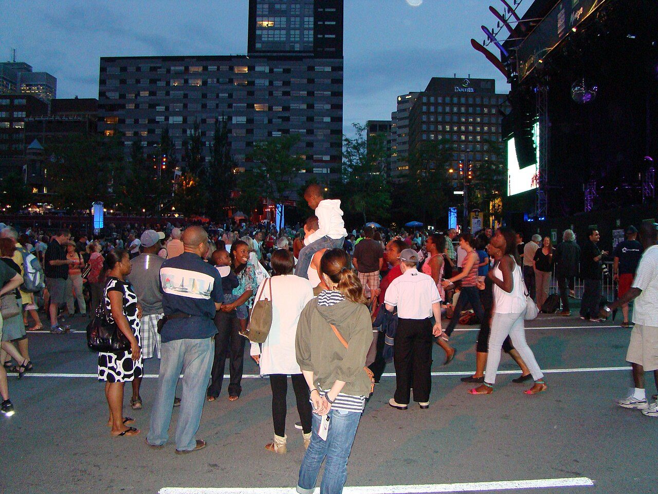 Crowd gathered for a nighttime outdoor concert at the Montreal International Jazz Festival