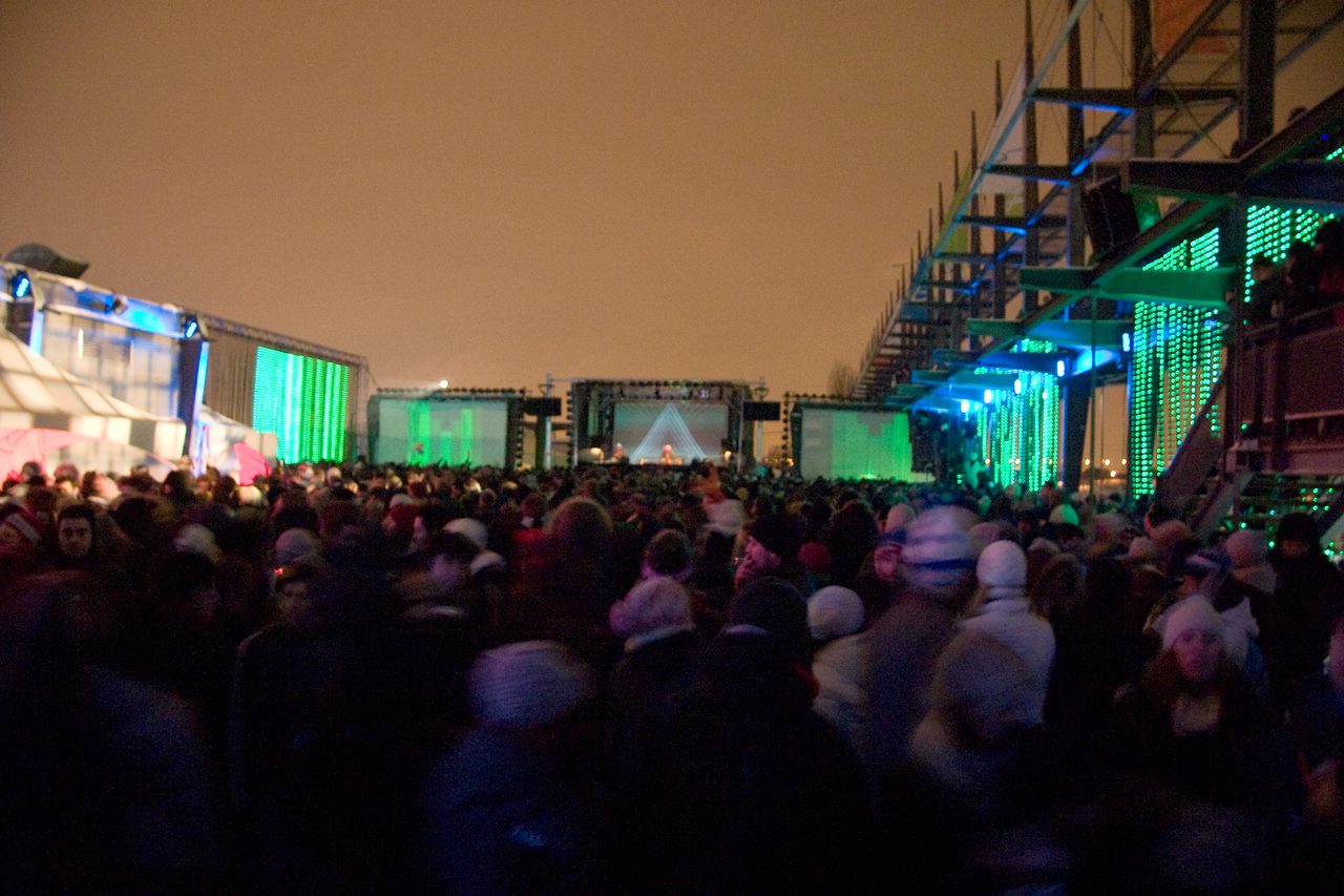 Crowd dancing in winter gear at the Igloofest electronic music festival in Montreal