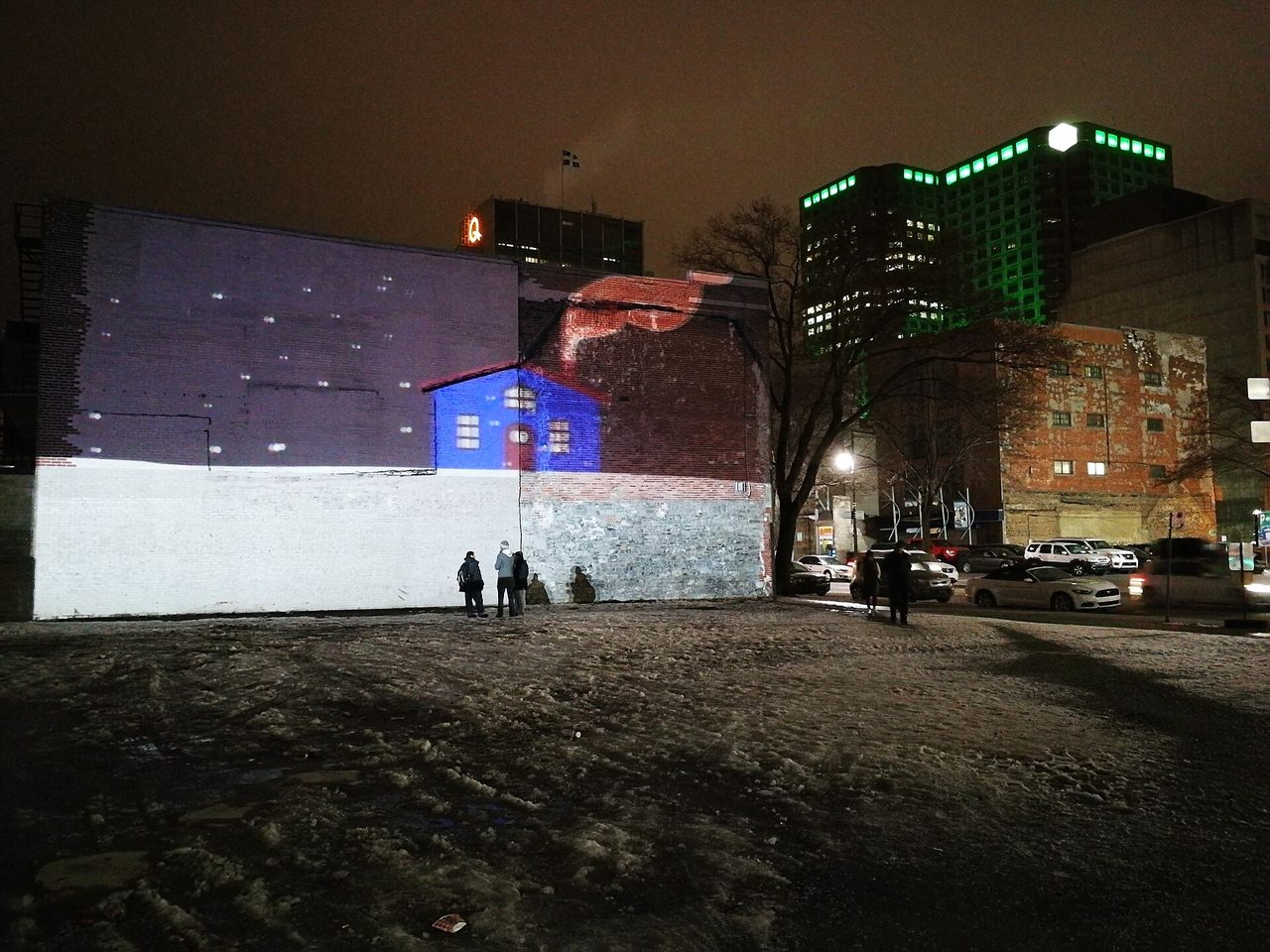 Night-time projection art glowing on a Montreal building facade