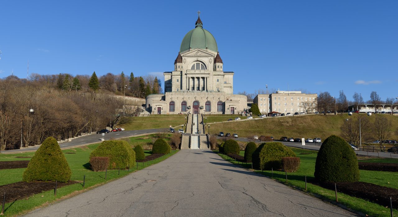 Saint Joseph's Oratory dome rising above the treeline on a clear day in Montreal