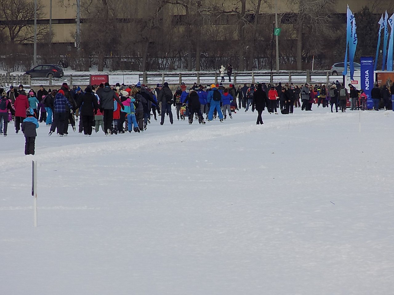 Skaters gliding along the frozen Rideau Canal Skateway in Ottawa in winter