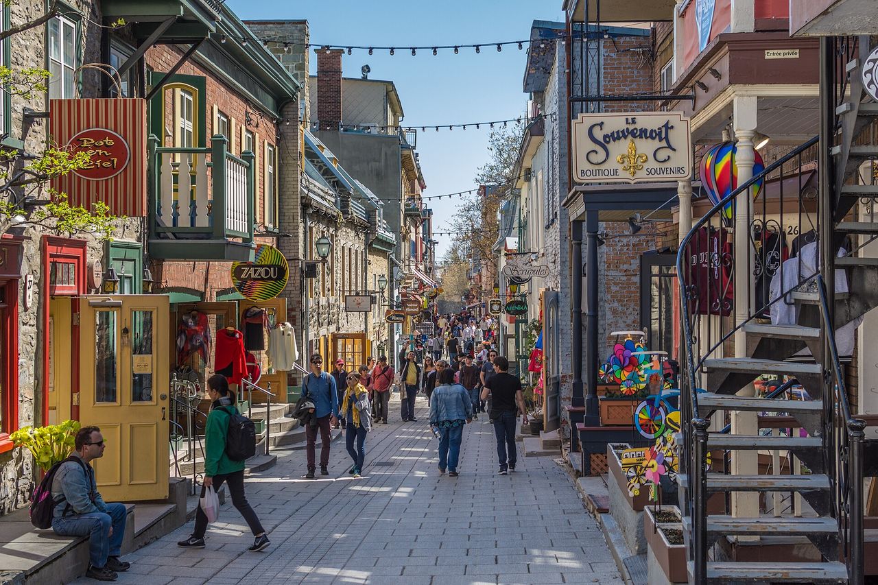Narrow cobblestone lane of the Petit-Champlain district lined with stone buildings and shops
