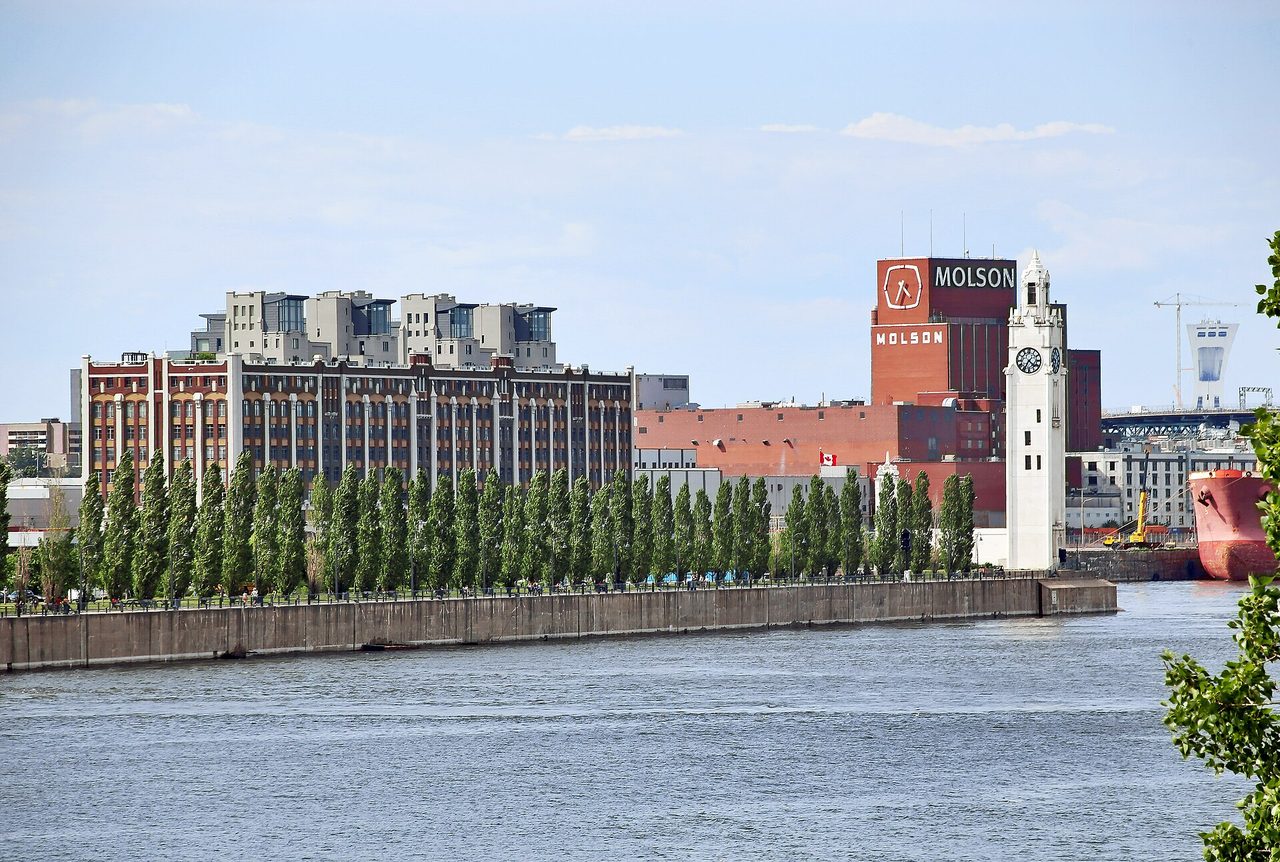 Montreal's Clock Tower and Molson brewery along the Old Port waterfront promenade