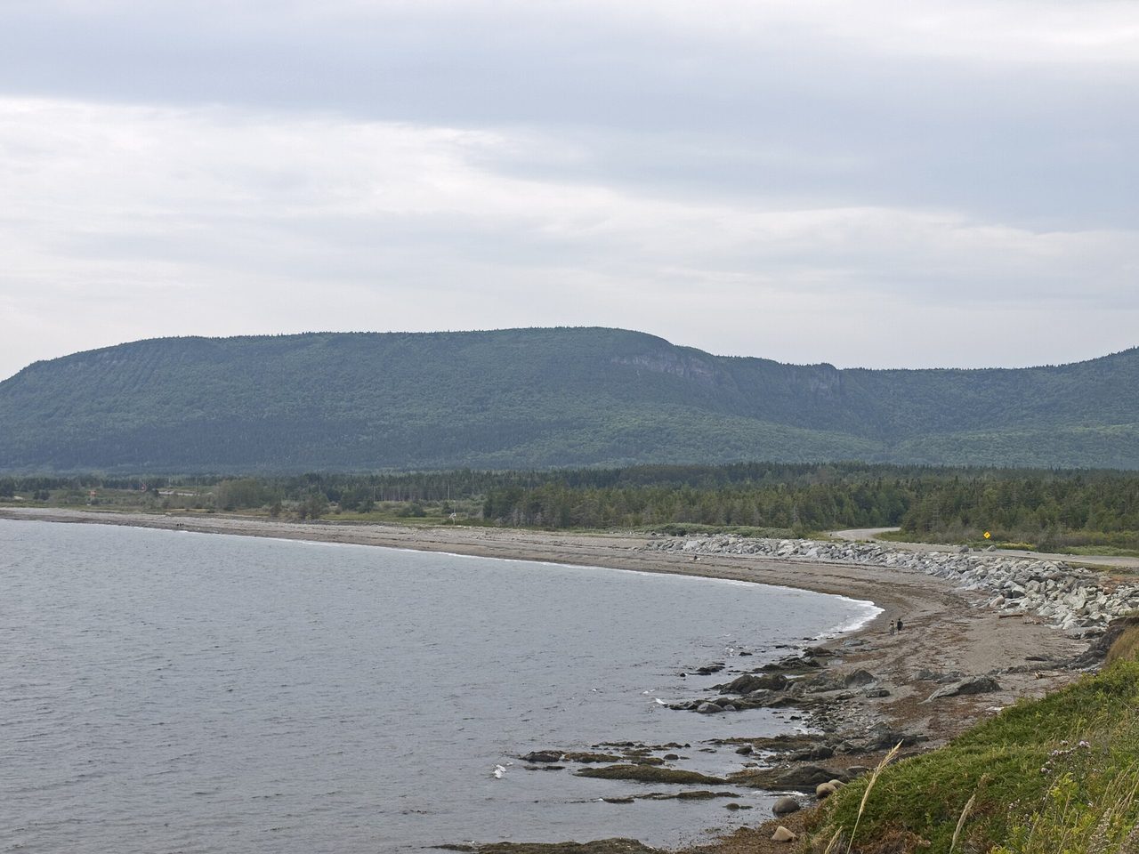 Rocky beach and forested cliffs on the coast of Forillon National Park, Gaspé