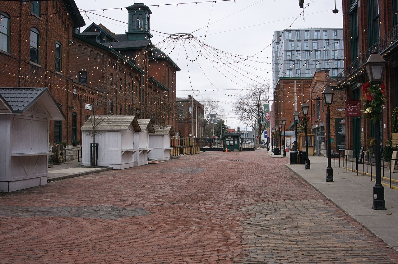 Cobblestone Trinity Street in Toronto's Distillery District lined with Victorian brick buildings
