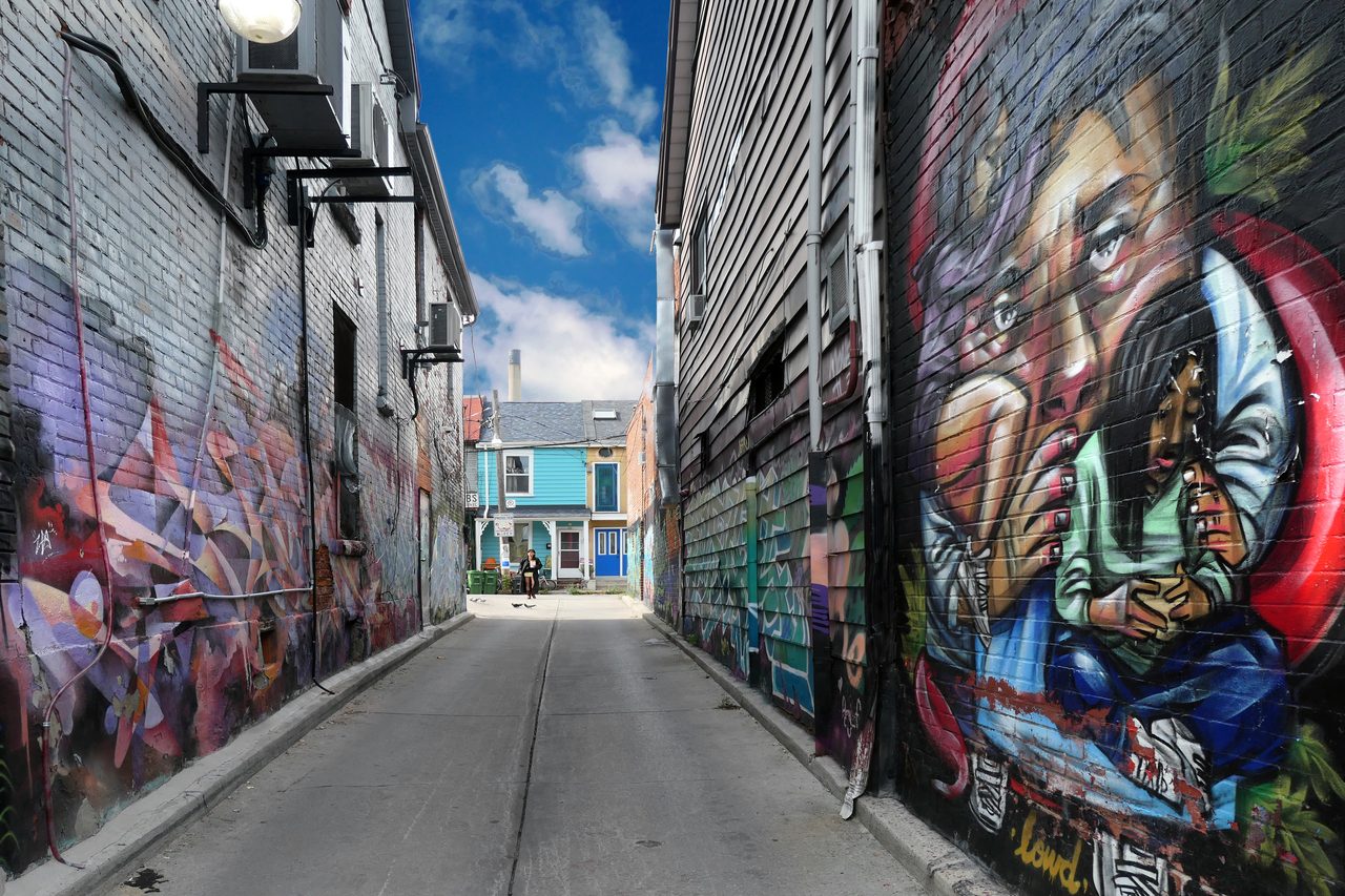Colorful murals covering building walls in Kensington Market, Toronto