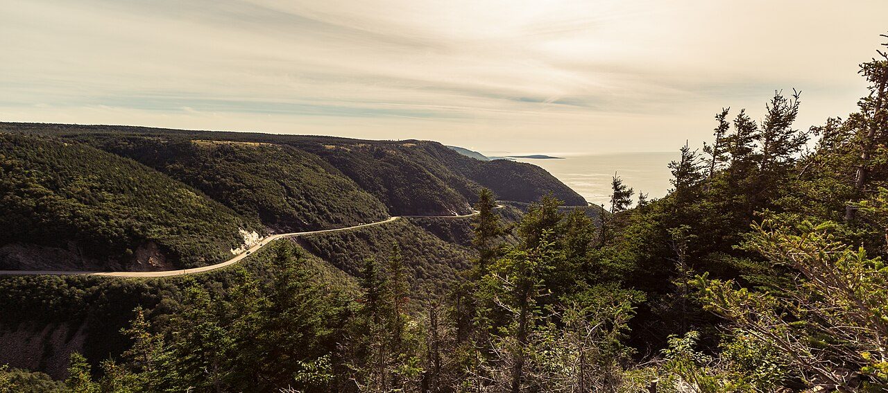The Cabot Trail winding through forested highlands toward the Gulf of St. Lawrence