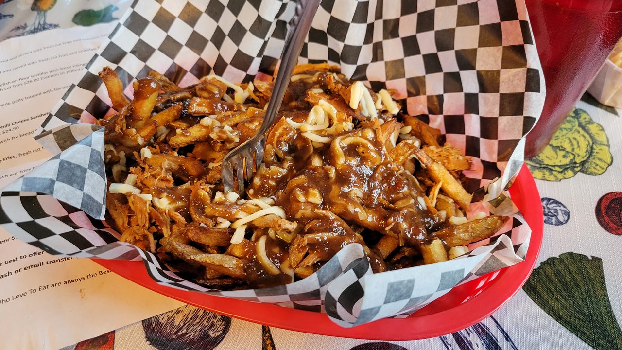 A classic Québec poutine: crispy fries, fresh cheese curds, and hot gravy