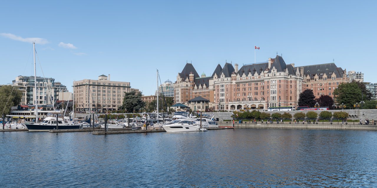 Victoria's Inner Harbour with the Fairmont Empress hotel along the waterfront at golden hour