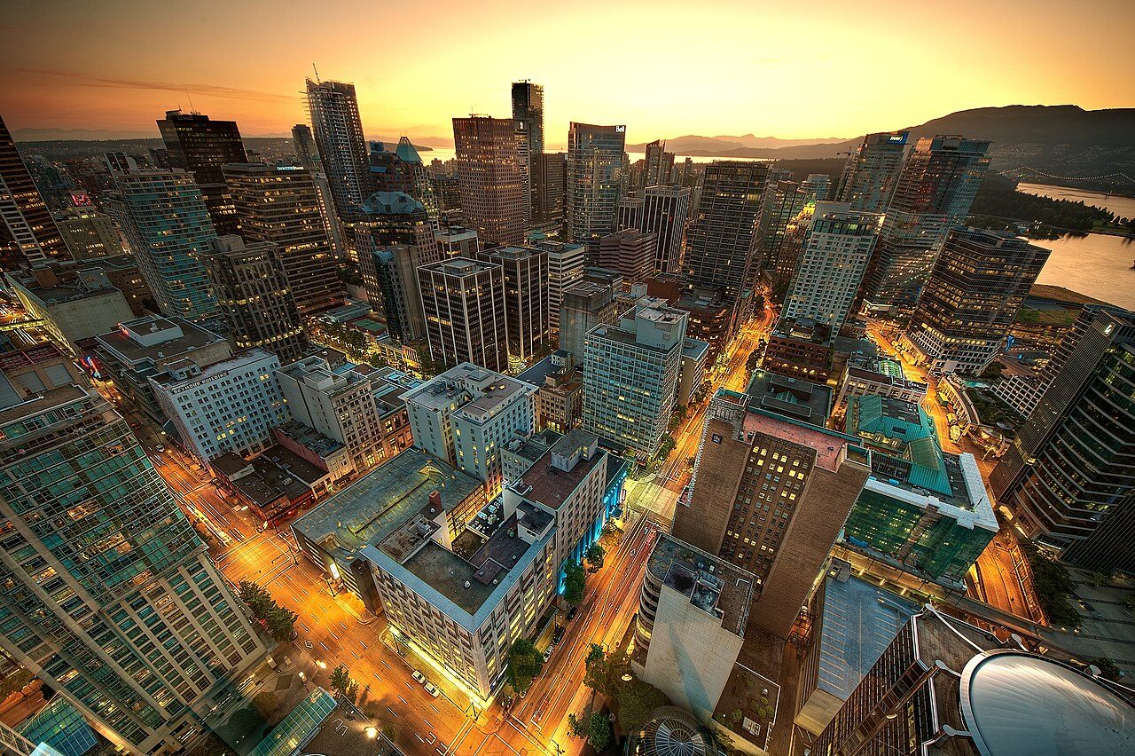 Downtown Vancouver skyline glowing at sunset over the water