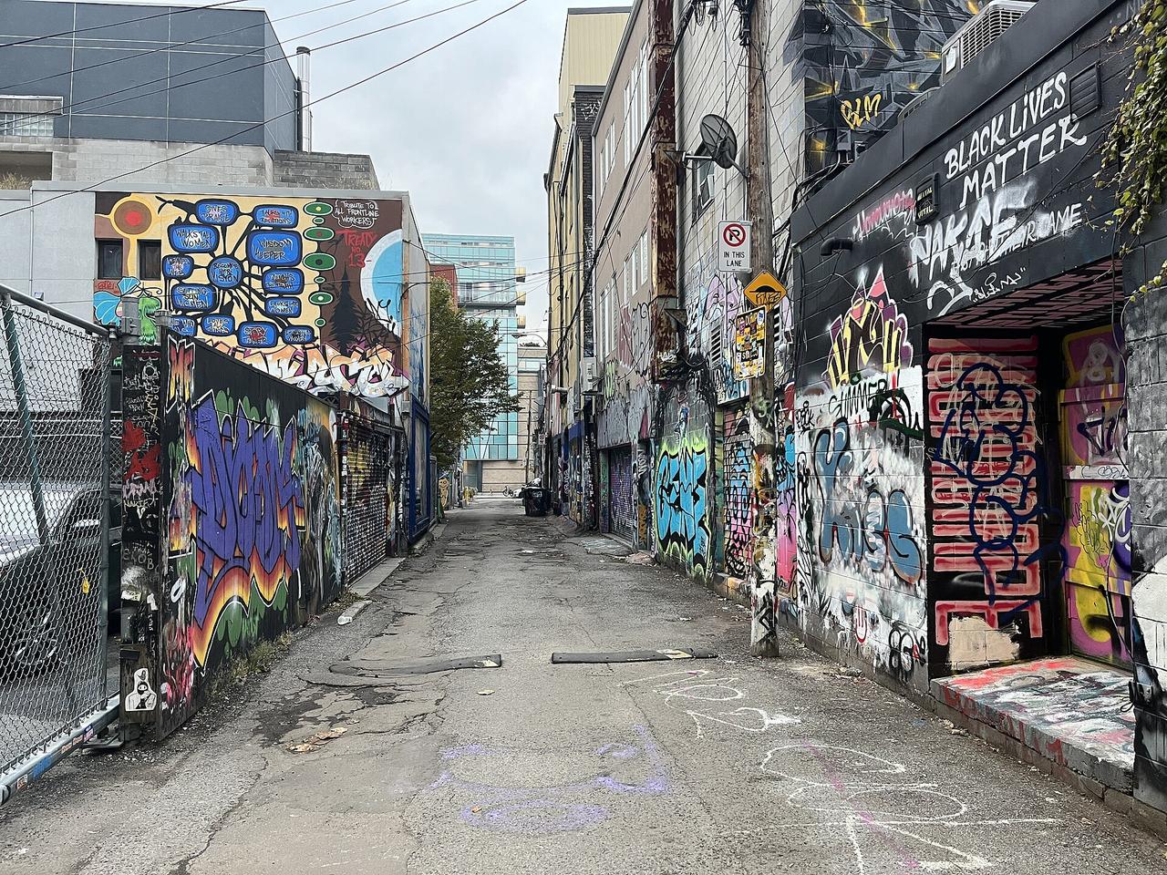 Colorful street art murals covering Graffiti Alley in Toronto's West Queen West neighborhood