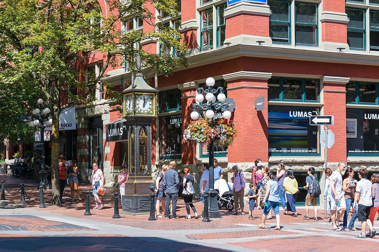 The Gastown Steam Clock surrounded by tourists on Water Street in Vancouver